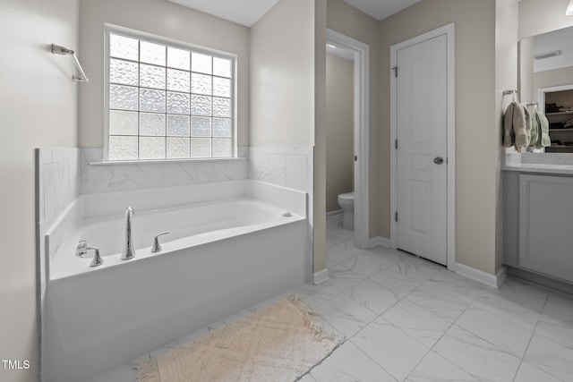 1304 Bromby Ave, Knightdale, NC 27545 - bathroom featuring a bath, marble look tiles, vanity, and a closet