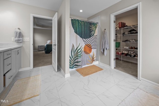 1304 Bromby Ave, Knightdale, NC 27545 - ensuite bathroom with marble finish flooring, vanity, a spacious closet, recessed lighting, and a shower with curtain