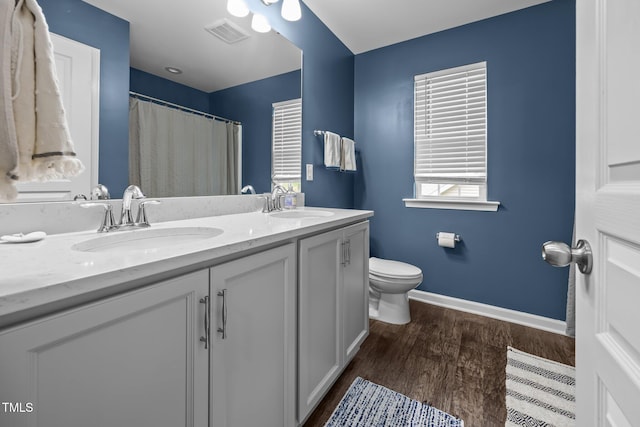 1304 Bromby Ave, Knightdale, NC 27545 - full bath with double vanity, wood finished floors, and a shower with shower curtain