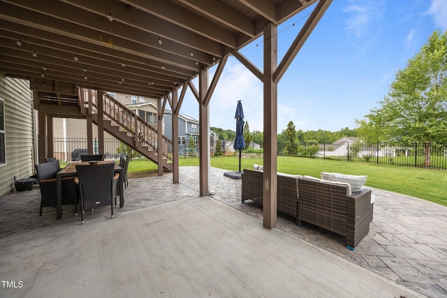 1304 Bromby Ave, Knightdale, NC 27545 - fenced backyard featuring stairs, a patio area, outdoor lounge area, and outdoor dining space