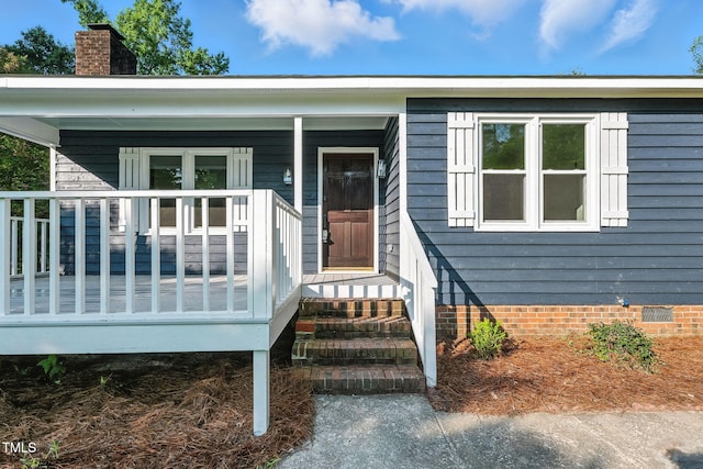 104 S Nikol Way, Clayton, NC 27520 - view of exterior entry with a chimney, crawl space, and a porch