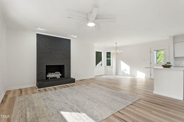 104 S Nikol Way, Clayton, NC 27520 - unfurnished living room with a chandelier, a ceiling fan, light wood-type flooring, a fireplace, and ornamental molding