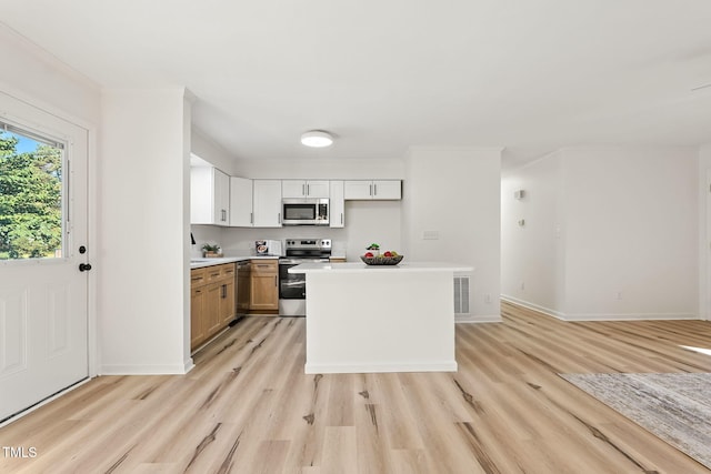 104 S Nikol Way, Clayton, NC 27520 - kitchen featuring stainless steel appliances, light wood finished floors, light countertops, and a center island