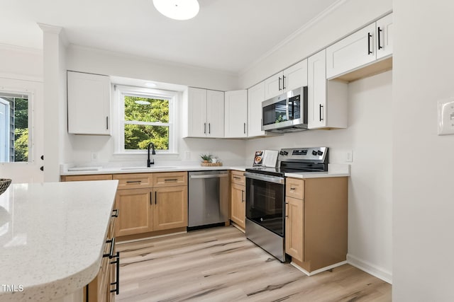 104 S Nikol Way, Clayton, NC 27520 - kitchen with appliances with stainless steel finishes, crown molding, light wood-type flooring, healthy amount of natural light, and light stone countertops