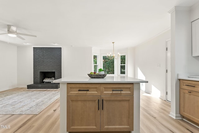 104 S Nikol Way, Clayton, NC 27520 - kitchen featuring light wood-style flooring, light countertops, a chandelier, crown molding, and a brick fireplace