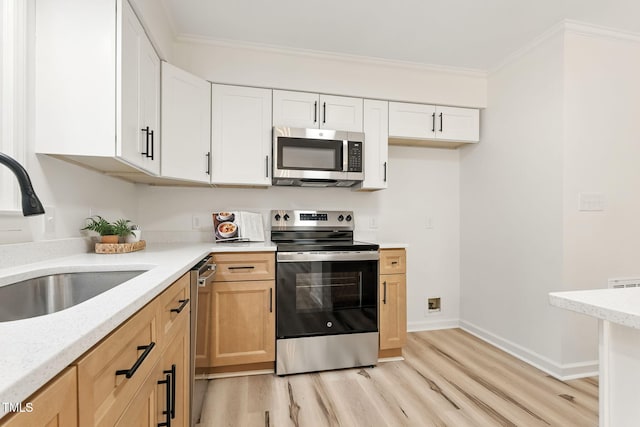 104 S Nikol Way, Clayton, NC 27520 - kitchen featuring appliances with stainless steel finishes, light wood-type flooring, crown molding, white cabinets, and light stone countertops