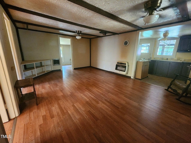 1080 Kudzu Ln, Danbury, NC 27016 - unfurnished living room with heating unit, a ceiling fan, wood finished floors, beam ceiling, and a textured ceiling