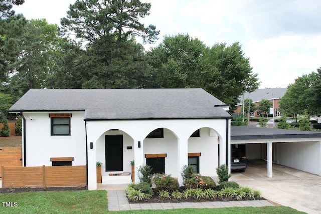 1523 Ivy Ln, Raleigh, NC 27609 - view of front facade featuring a shingled roof, driveway, and an attached carport