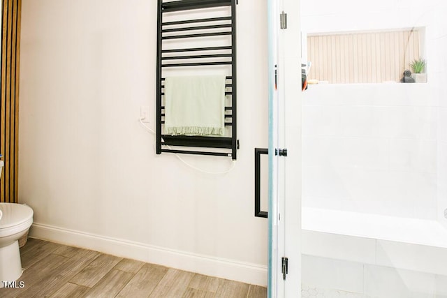 1523 Ivy Ln, Raleigh, NC 27609 - full bathroom featuring wood finished floors, radiator heating unit, and a towel warmer