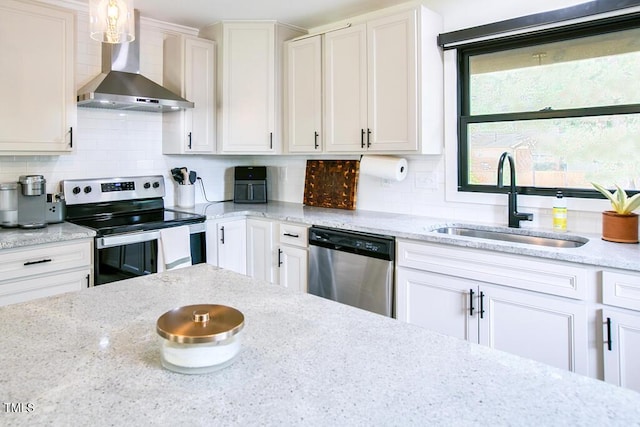 1523 Ivy Ln, Raleigh, NC 27609 - kitchen with wall chimney exhaust hood, appliances with stainless steel finishes, white cabinets, light stone counters, and tasteful backsplash