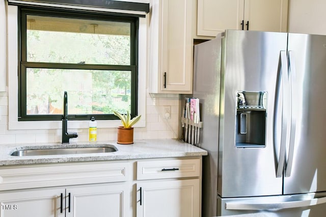 1523 Ivy Ln, Raleigh, NC 27609 - kitchen with stainless steel refrigerator with ice dispenser, tasteful backsplash, and light stone counters