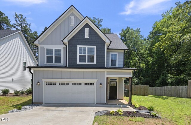 1254 Camden Ave, Durham, NC 27701 - view of front of house featuring board and batten siding, a garage, concrete driveway, and roof with shingles