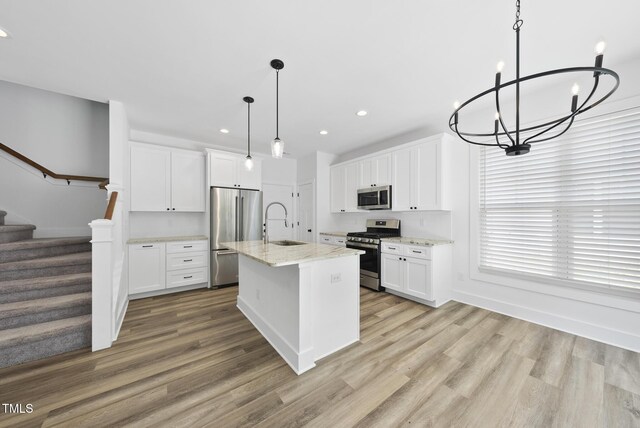1254 Camden Ave, Durham, NC 27701 - kitchen with appliances with stainless steel finishes, a chandelier, light wood finished floors, recessed lighting, and light stone countertops