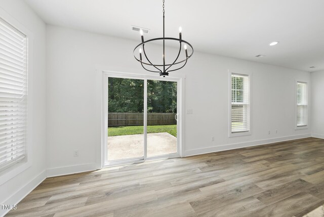 1254 Camden Ave, Durham, NC 27701 - unfurnished dining area with a chandelier, light wood-type flooring, and recessed lighting