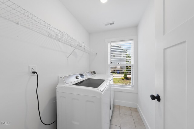 1254 Camden Ave, Durham, NC 27701 - washroom featuring separate washer and dryer and light tile patterned flooring