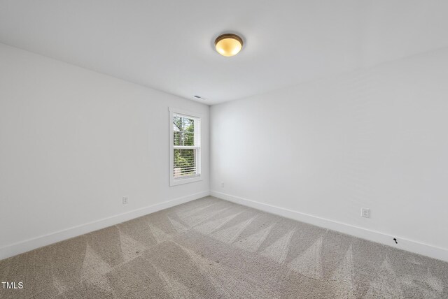 1254 Camden Ave, Durham, NC 27701 - carpeted empty room with baseboards