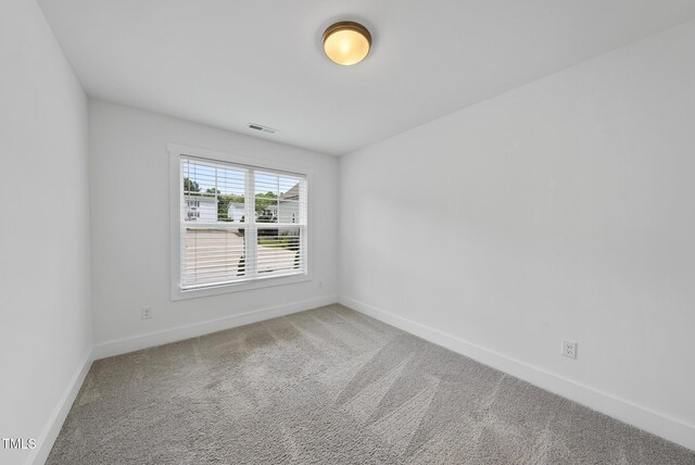 1254 Camden Ave, Durham, NC 27701 - spare room featuring carpet flooring and baseboards