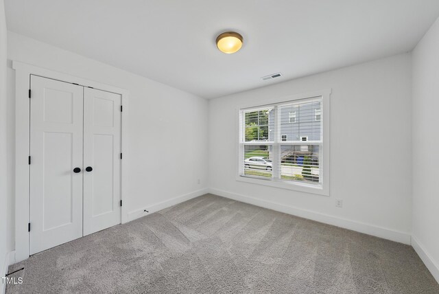 1254 Camden Ave, Durham, NC 27701 - unfurnished bedroom featuring carpet and a closet