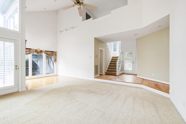 2944 Ballybunion Way, Raleigh, NC 27613 - empty room with carpet floors, a high ceiling, stairway, and ceiling fan
