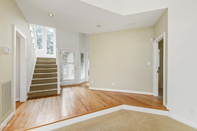 2944 Ballybunion Way, Raleigh, NC 27613 - spare room featuring stairs, wood finished floors, and recessed lighting