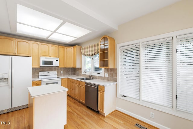 2944 Ballybunion Way, Raleigh, NC 27613 - kitchen featuring white appliances, light brown cabinets, light wood-style floors, and tasteful backsplash