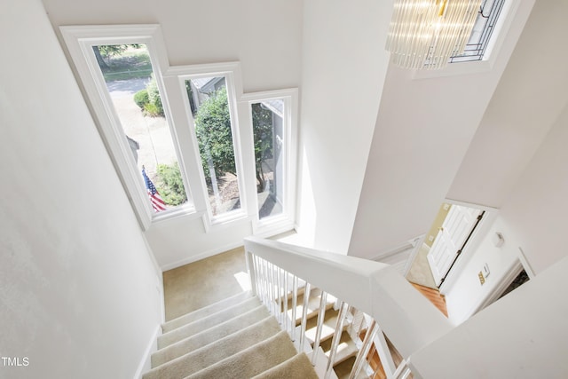 2944 Ballybunion Way, Raleigh, NC 27613 - staircase featuring a towering ceiling, carpet, and a chandelier