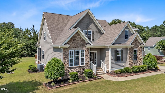 1012 Tavernier Knoll Ln, Raleigh, NC 27603 - view of front of house with stone siding, a front lawn, and a shingled roof