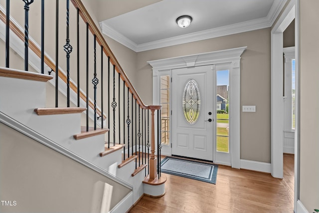 1012 Tavernier Knoll Ln, Raleigh, NC 27603 - entrance foyer with wood finished floors, crown molding, and stairs