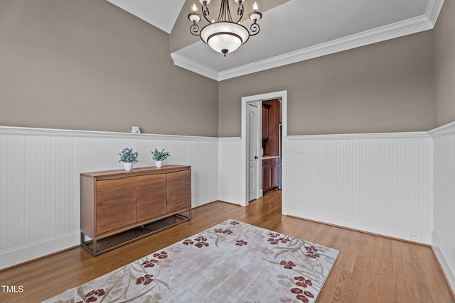1012 Tavernier Knoll Ln, Raleigh, NC 27603 - sitting room with wainscoting, a chandelier, crown molding, wood finished floors, and vaulted ceiling