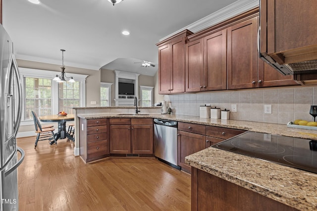 1012 Tavernier Knoll Ln, Raleigh, NC 27603 - kitchen featuring stainless steel appliances, light wood-style flooring, tasteful backsplash, a peninsula, and recessed lighting