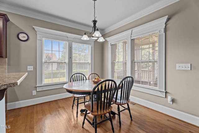 1012 Tavernier Knoll Ln, Raleigh, NC 27603 - dining area featuring light wood-type flooring, ornamental molding, and a chandelier