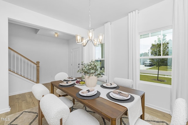 34 Mable Ct Unit 22, Lillington, NC 27546 - dining area featuring a chandelier, light wood-style flooring, and stairs