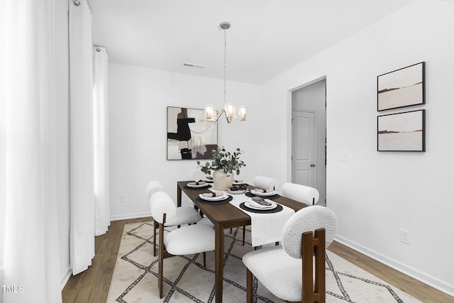 34 Mable Ct Unit 22, Lillington, NC 27546 - dining area featuring a chandelier and wood finished floors