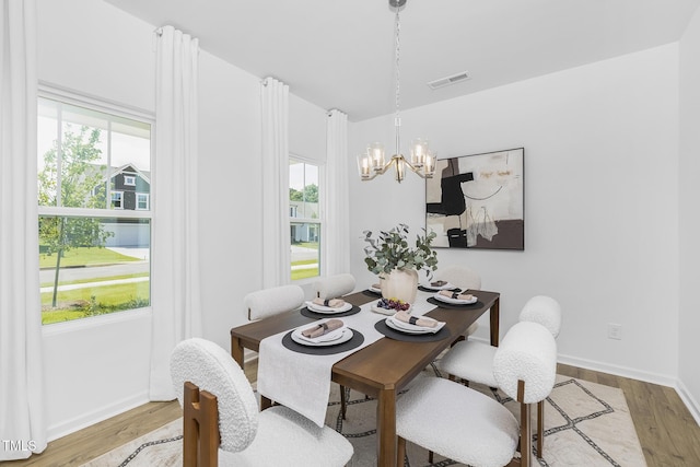 34 Mable Ct Unit 22, Lillington, NC 27546 - dining room featuring light wood-style flooring and a chandelier