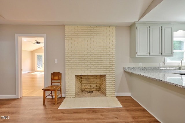 369 Historic Village Dr, Roxboro, NC 27574 - living area with lofted ceiling, wood finished floors, a ceiling fan, and a fireplace