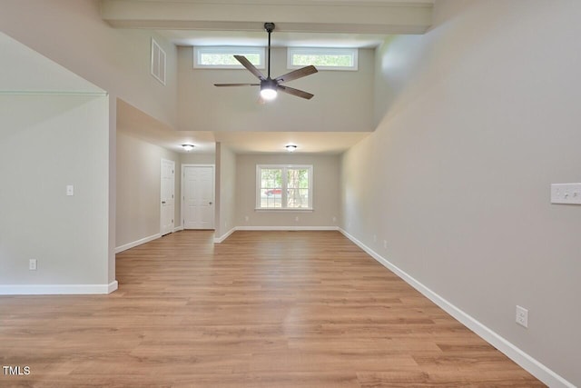 369 Historic Village Dr, Roxboro, NC 27574 - unfurnished living room with a towering ceiling, ceiling fan, and light wood-style floors