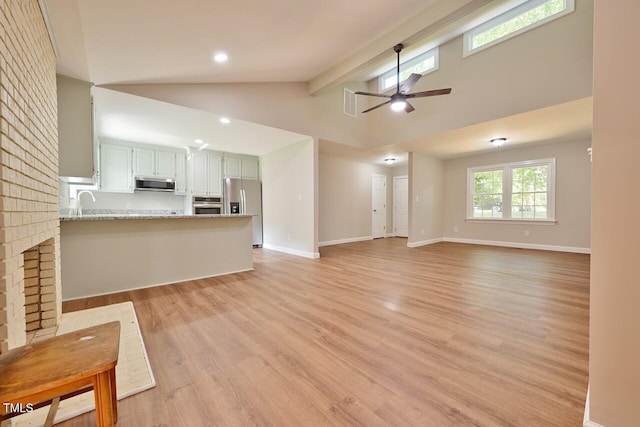 369 Historic Village Dr, Roxboro, NC 27574 - unfurnished living room with light wood-style flooring, ceiling fan, beam ceiling, high vaulted ceiling, and recessed lighting