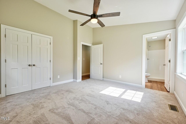 369 Historic Village Dr, Roxboro, NC 27574 - unfurnished bedroom with carpet floors, vaulted ceiling, a closet, ensuite bath, and a ceiling fan
