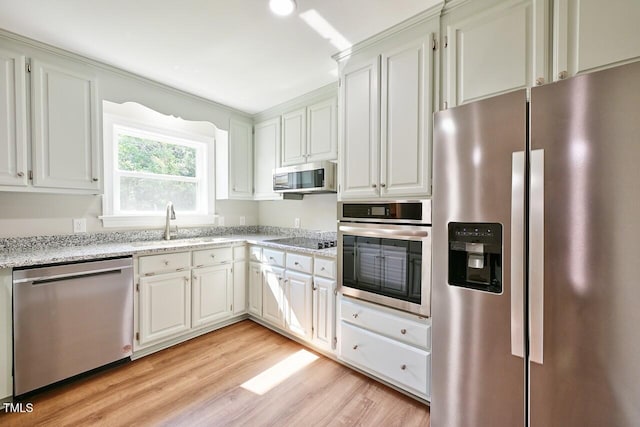 369 Historic Village Dr, Roxboro, NC 27574 - kitchen featuring stainless steel appliances, light wood-style flooring, light stone counters, and white cabinets
