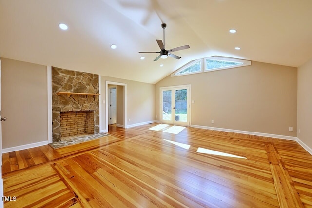 369 Historic Village Dr, Roxboro, NC 27574 - unfurnished living room with wood-type flooring, ceiling fan, a stone fireplace, vaulted ceiling, and french doors