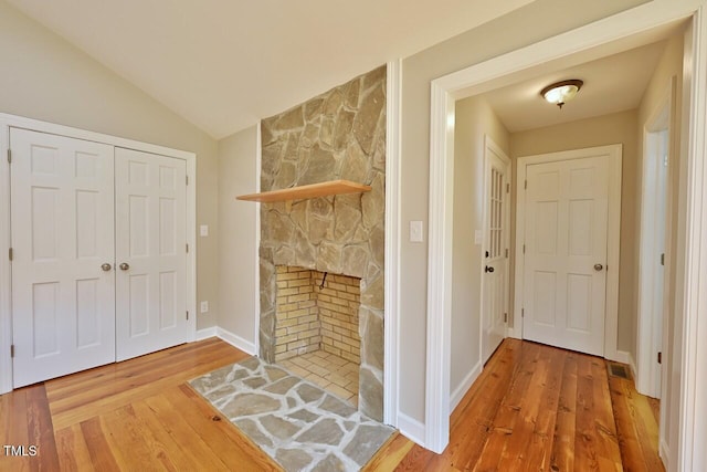 369 Historic Village Dr, Roxboro, NC 27574 - unfurnished living room featuring wood finished floors, a fireplace, and vaulted ceiling