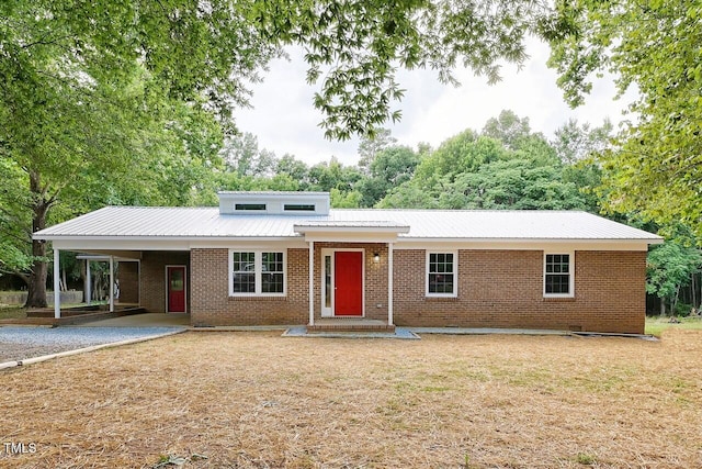 369 Historic Village Dr, Roxboro, NC 27574 - view of front facade featuring a carport, brick siding, a metal roof, and a front lawn