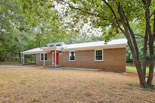 369 Historic Village Dr, Roxboro, NC 27574 - view of front facade with brick siding, an attached carport, and a metal roof