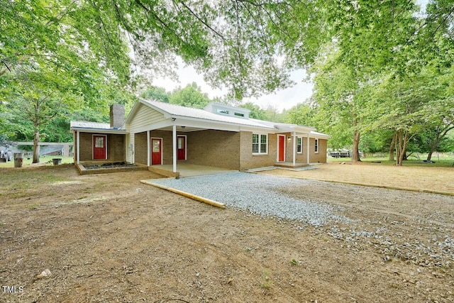 369 Historic Village Dr, Roxboro, NC 27574 - single story home with driveway, a chimney, a carport, and brick siding
