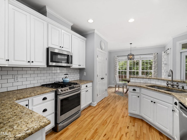 20 Little River Ct, Youngsville, NC 27596 - kitchen featuring stainless steel appliances, crown molding, white cabinets, and recessed lighting