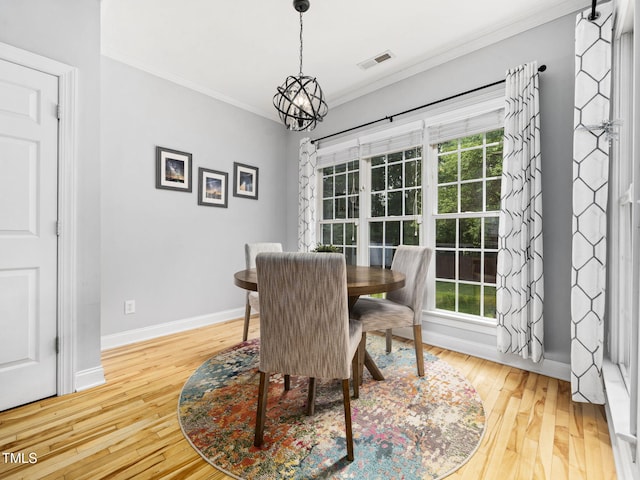 20 Little River Ct, Youngsville, NC 27596 - dining space featuring crown molding, plenty of natural light, wood-type flooring, and a chandelier