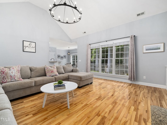 20 Little River Ct, Youngsville, NC 27596 - living area featuring a chandelier, wood finished floors, and high vaulted ceiling