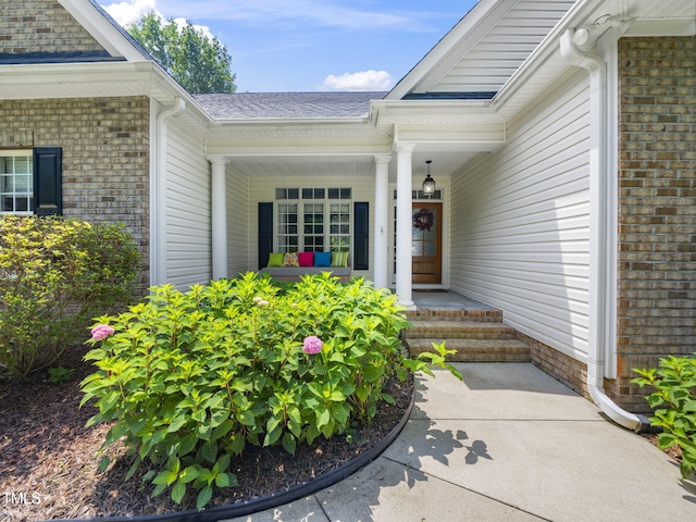 20 Little River Ct, Youngsville, NC 27596 - property entrance with a porch, brick siding, and roof with shingles