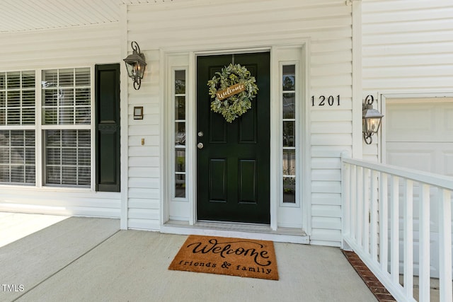 1201 Woodlands Creek Way, Apex, NC 27502 - view of exterior entry featuring a porch and a garage