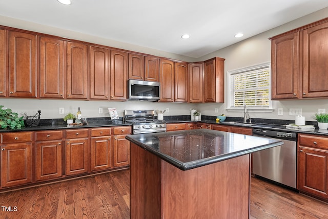 1201 Woodlands Creek Way, Apex, NC 27502 - kitchen with stainless steel appliances, recessed lighting, dark wood finished floors, dark stone counters, and a center island